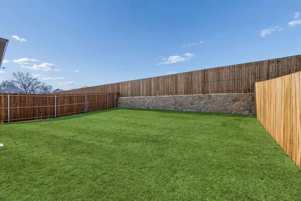 a view of yard with wooden fence