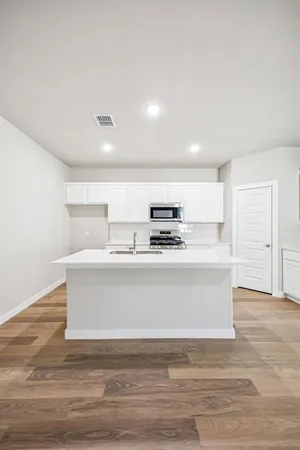 a view with kitchen island a sink and a stove