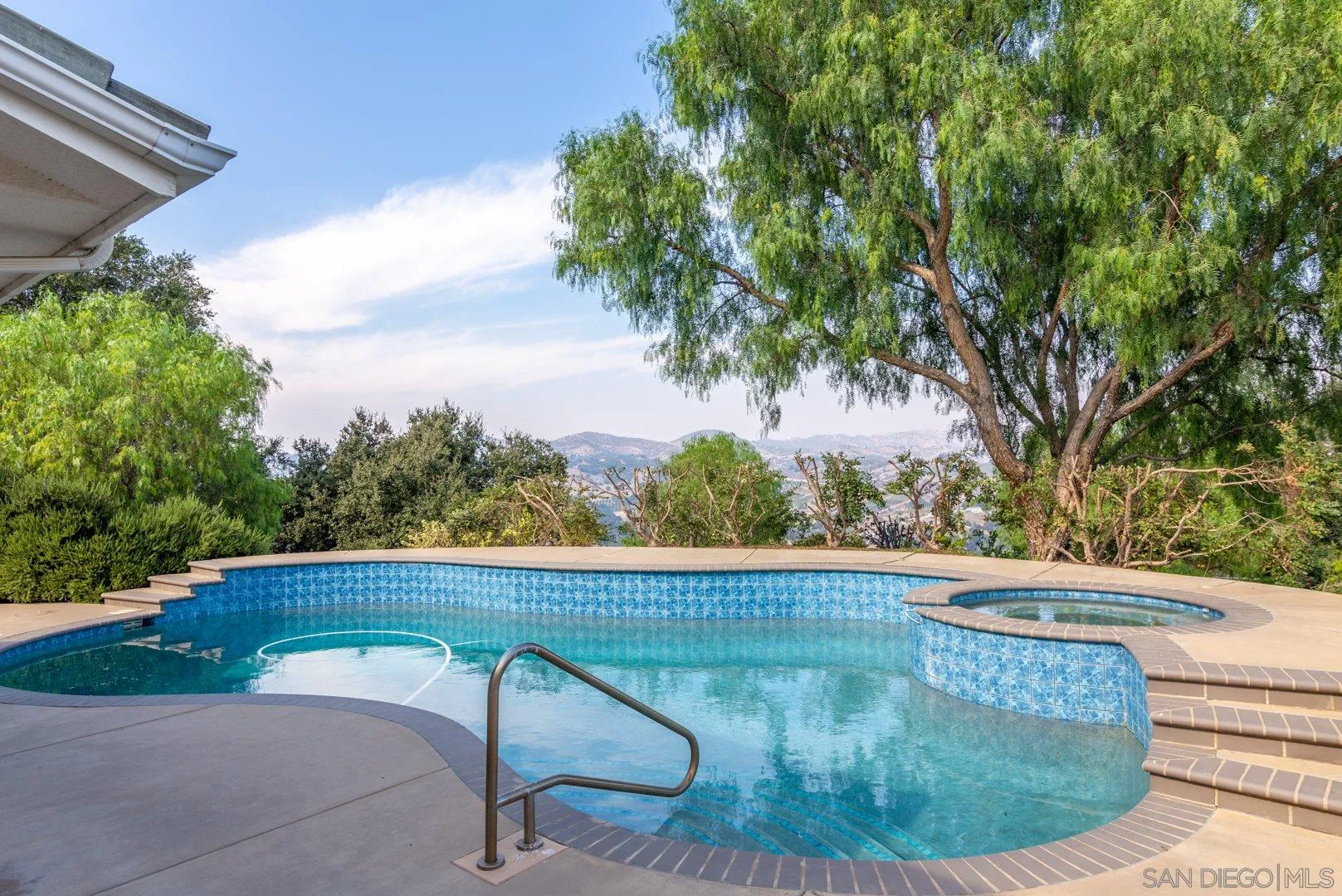 3880 Dos Ninos Road Fallbrook, CA 92028 - Photo 13 of 39 a view of a swimming pool with a outdoor seating
