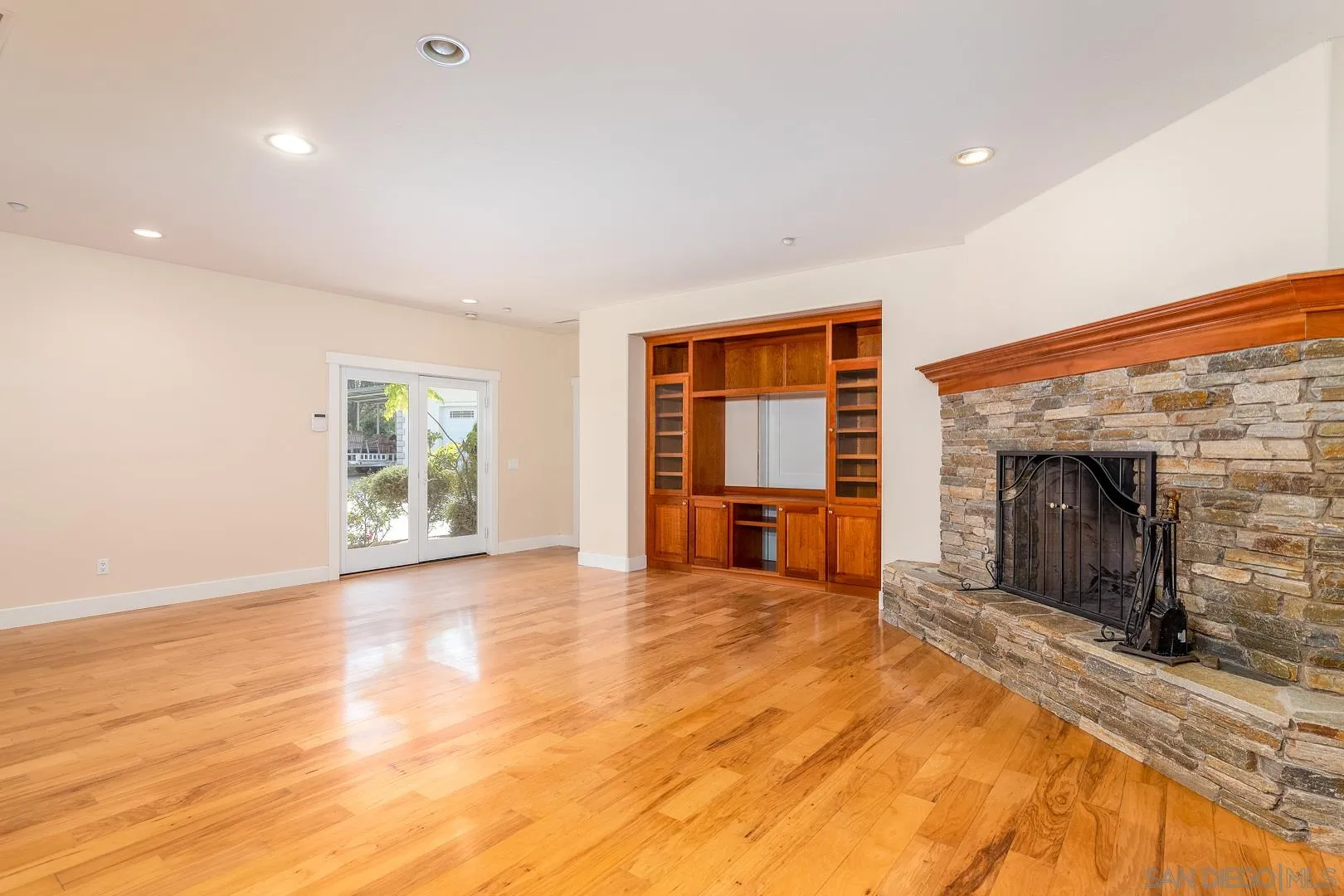 3880 Dos Ninos Road Fallbrook, CA 92028 - Photo 19 of 39 a view of an empty room with a fireplace and a window
