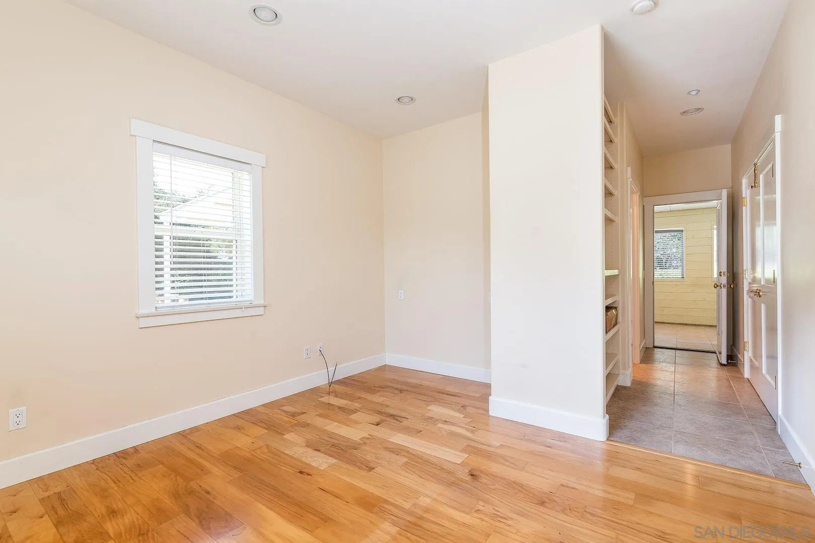 3880 Dos Ninos Road Fallbrook, CA 92028 - Photo 31 of 39 a view of an empty room with wooden floor and a bathroom