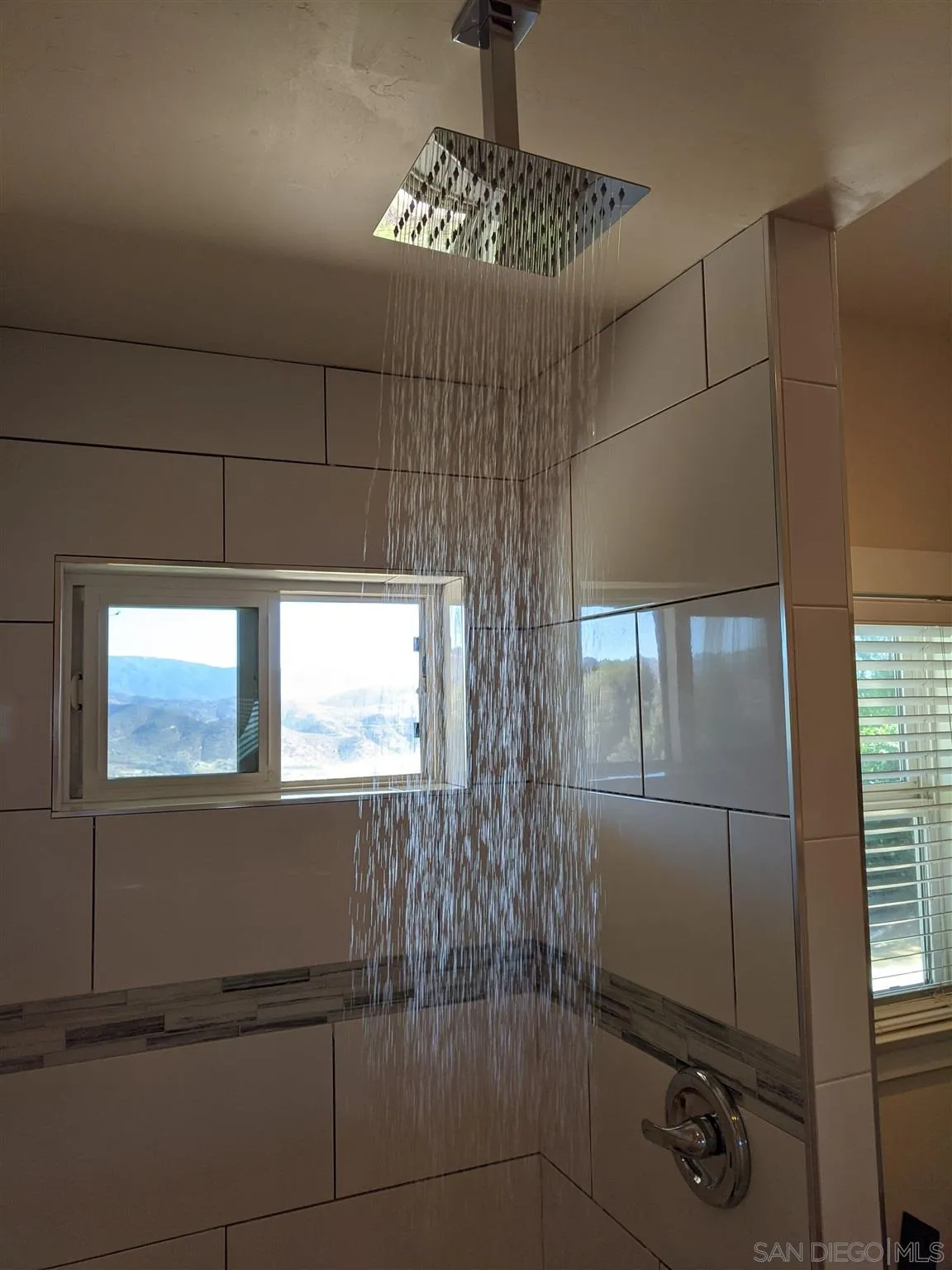 3880 Dos Ninos Road Fallbrook, CA 92028 - Photo 37 of 39 a bathroom with a window and a shower