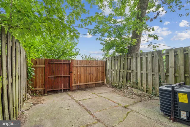 a view of a backyard with wooden fence