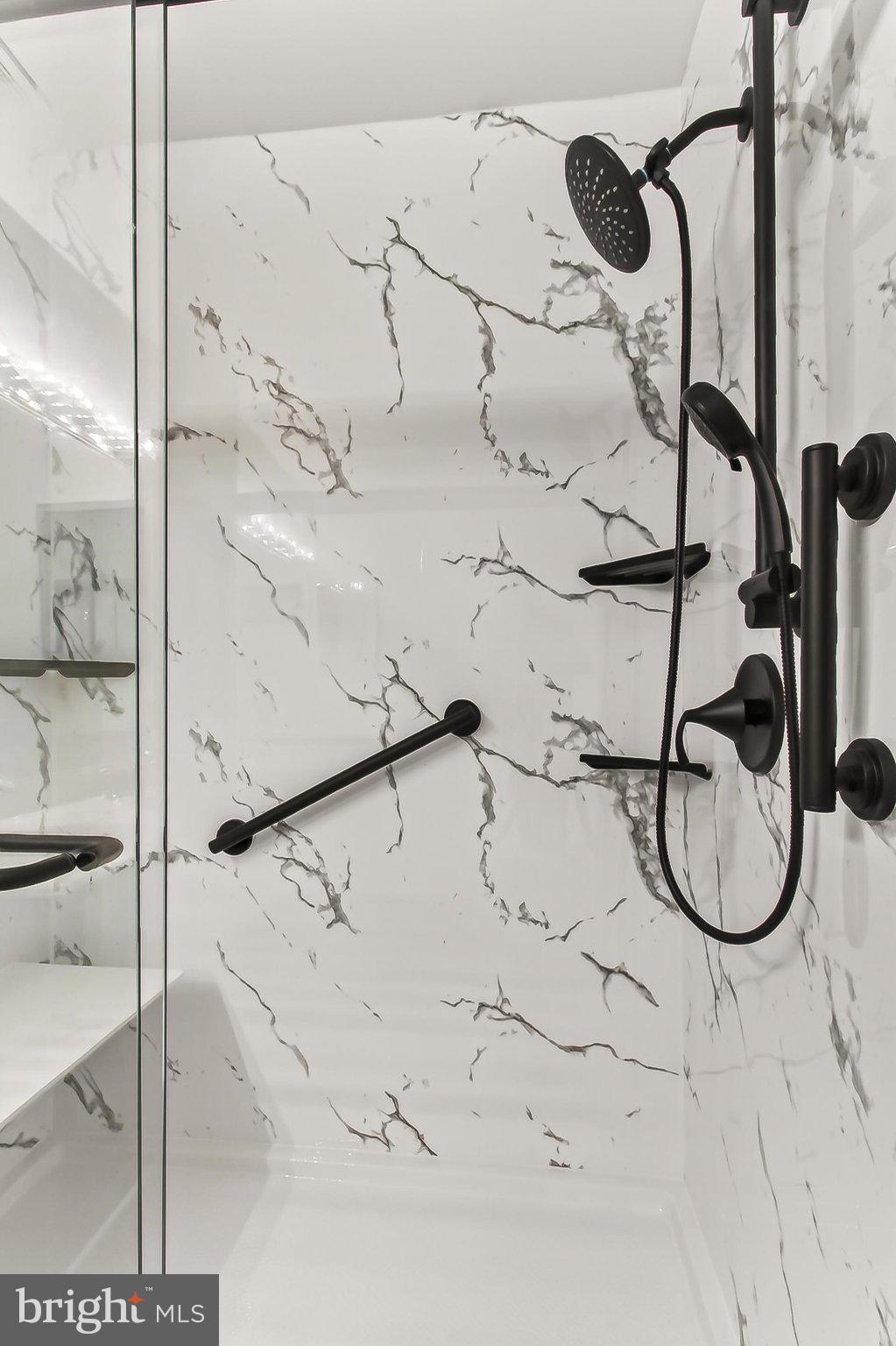 13157 Kidwell Field Road Herndon, VA 20171 - Photo 29 of 50 Sleek marble shower with modern fixtures.