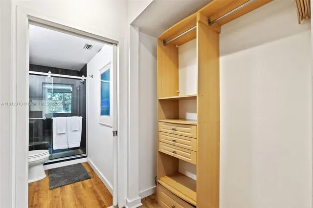 a bathroom with a sink toilet vanity and shower