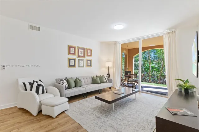 a living room with furniture and large window
