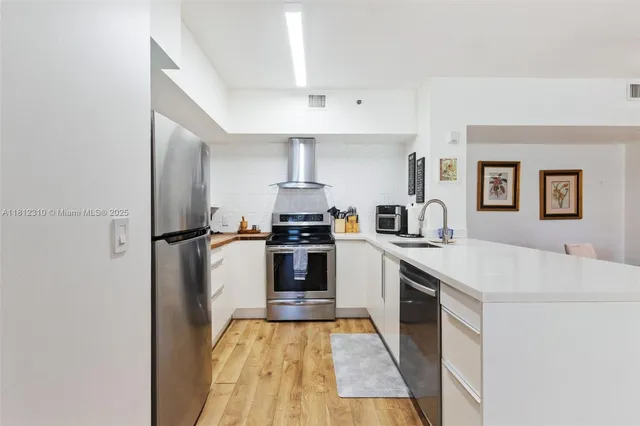 a kitchen with cabinets and appliances
