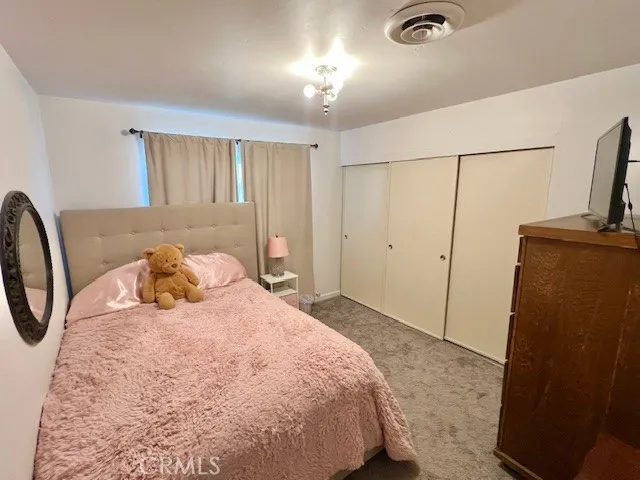 a bedroom with a bed and a mirror