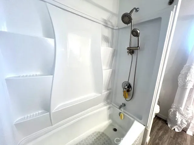 a bathroom with a tub and a shower