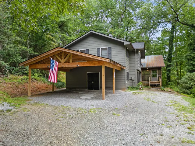 a view of a house with a yard and roof