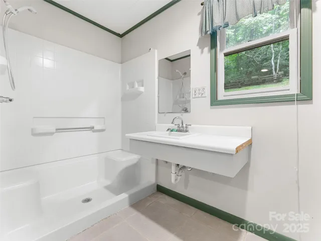 a room with white cabinets and refrigerator