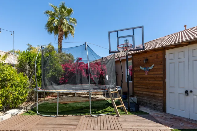 a view of a chairs and table in the back yard