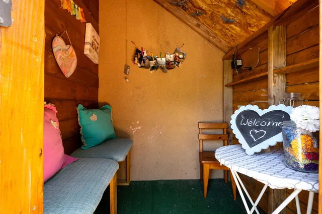 a view of a patio with table and chairs potted plants