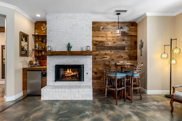 a kitchen with a stove and a wooden floor