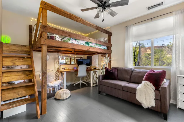 a living room with furniture gym equipment and a flat screen tv