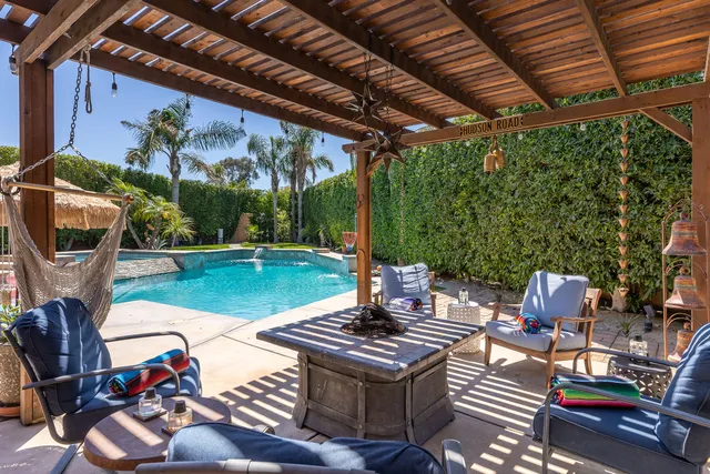 a view of a backyard with furniture and a fire pit