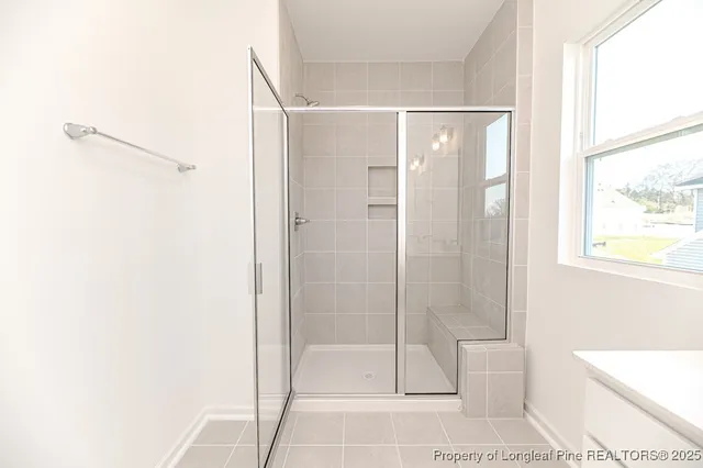a bathroom with a glass shower door