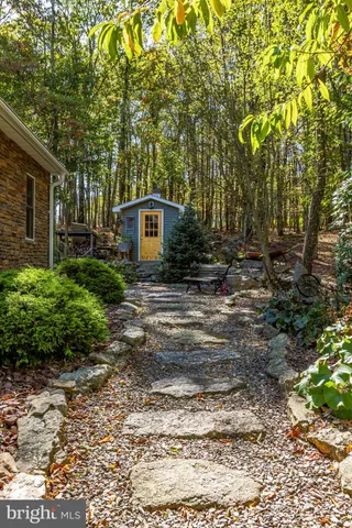 a kitchen with stainless steel appliances granite countertop a sink a stove and a window