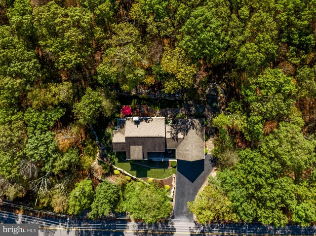 a view of a livingroom with furniture wooden floor windows and a chandelier