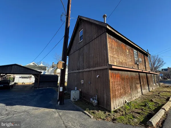 a view of a house with a patio and wooden fence