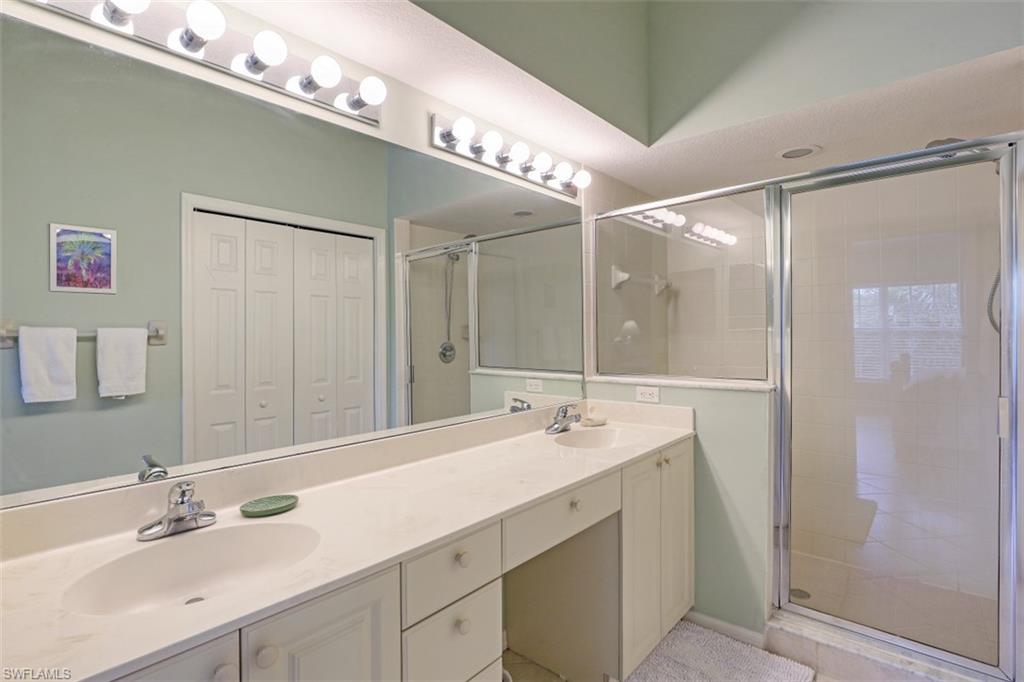 5630 Sherborn Drive, Unit 202 Naples, FL 34110 - Photo 11 of 18 a bathroom with a double vanity sink mirror and double