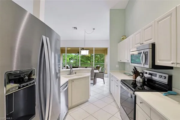 a kitchen with stainless steel appliances a refrigerator sink and stove
