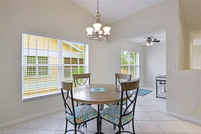 a view of a dining room with furniture and chandelier