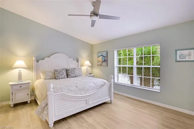 a bedroom with a bed lamp and a window