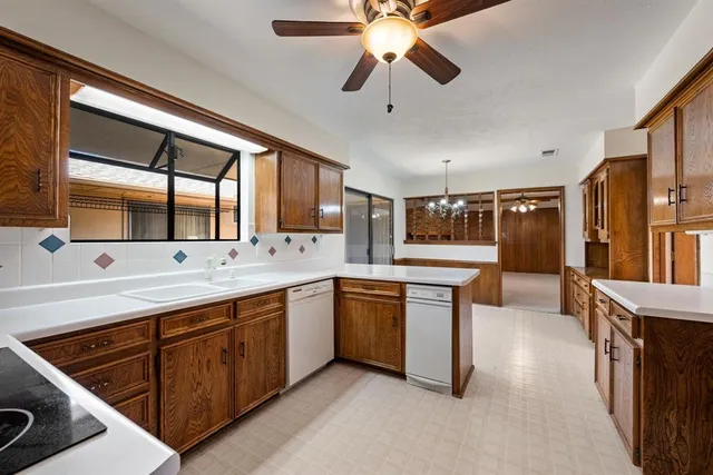 a kitchen with stainless steel appliances granite countertop a sink and stove