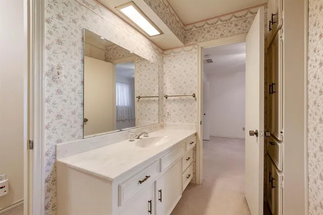 a bathroom with a sink and a mirror