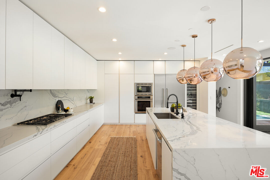 2624 Naples Avenue Venice, CA 90291 - Photo 12 of 38 a large kitchen with kitchen island a large counter top a sink and a stove