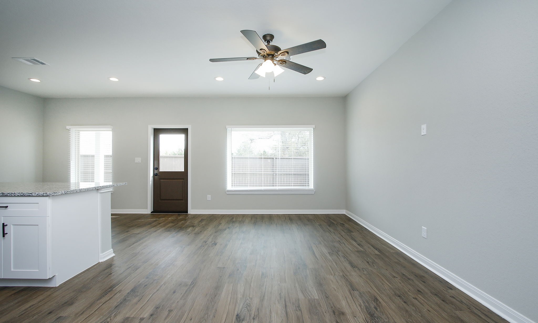 14010 Longstreet Road, Unit 4 Willis, TX 77318 - Photo 7 of 42 a view of an empty room with a window and wooden floor