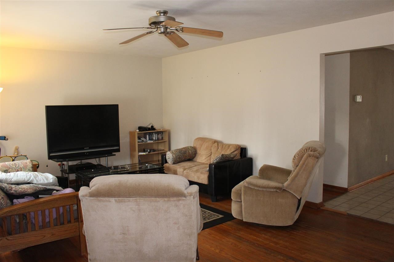 4212 Highcrest Road Rockford, IL 61107 - Photo 5 of 14 a living room with furniture and a flat screen tv