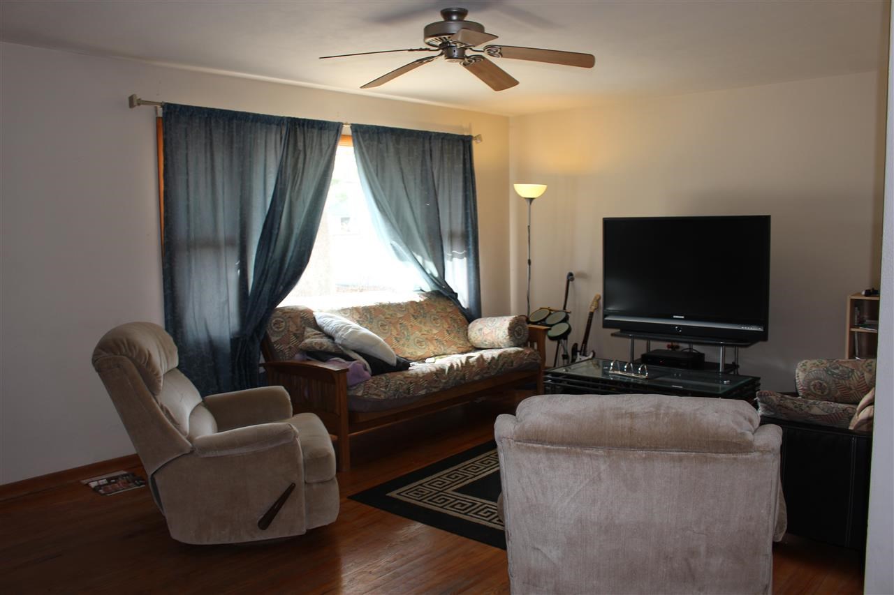 4212 Highcrest Road Rockford, IL 61107 - Photo 6 of 14 a living room with furniture and a flat screen tv