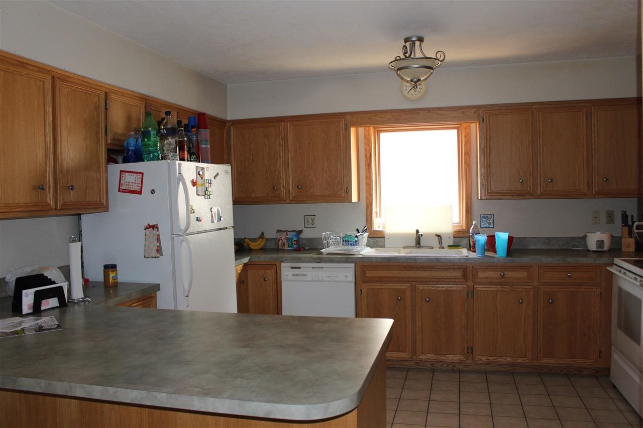 4212 Highcrest Road Rockford, IL 61107 - Photo 9 of 14 a kitchen with a sink a refrigerator and window