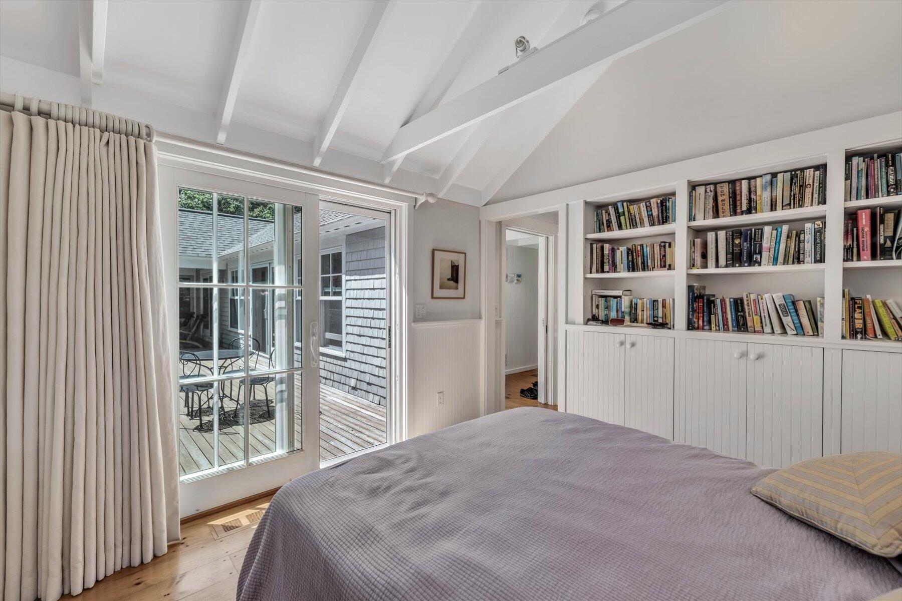 16 Tom's Hill Road Truro, MA 02666 - Photo 13 of 27 a bedroom with furniture and a book shelf