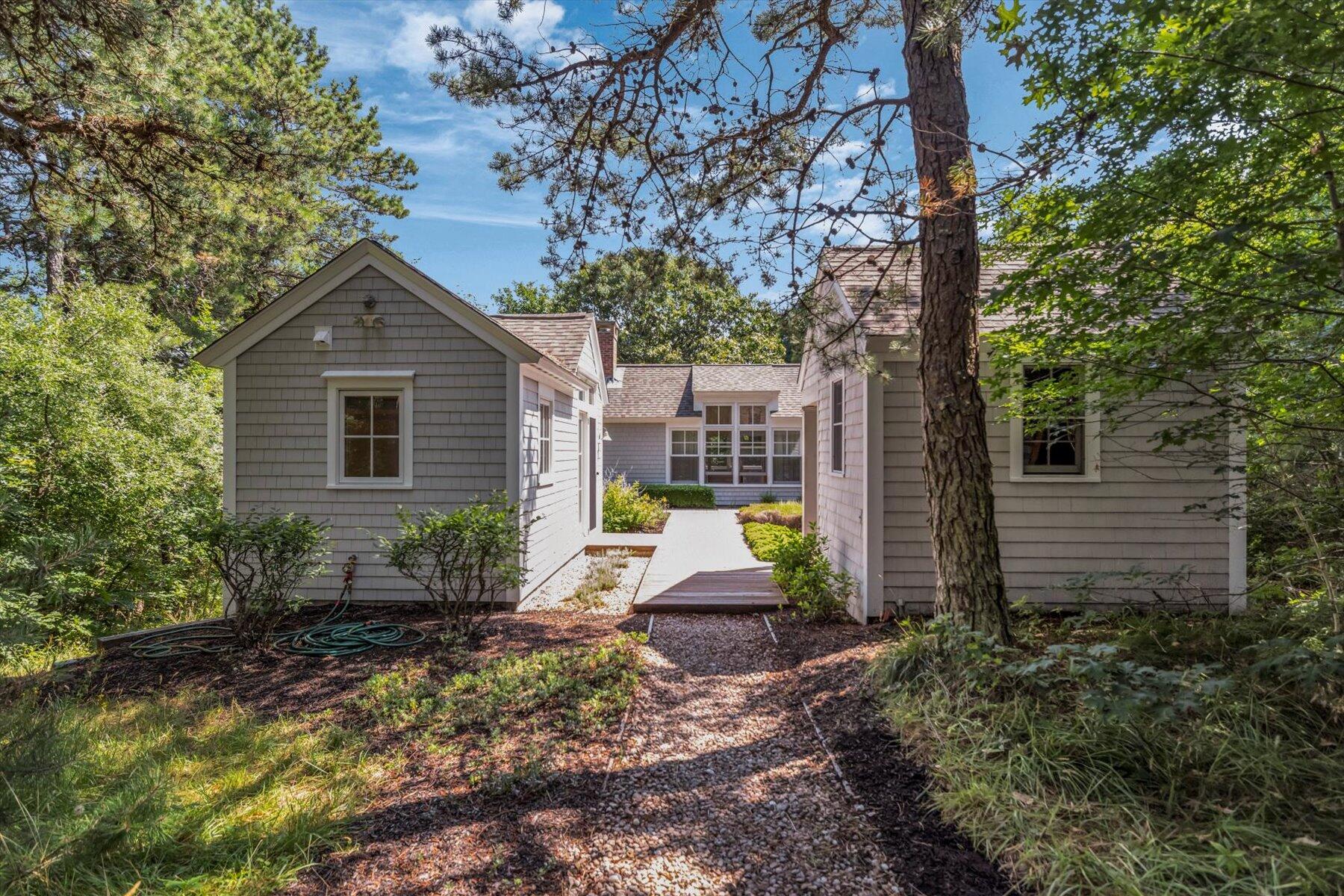 16 Tom's Hill Road Truro, MA 02666 - Photo 16 of 27 a view of a brick house with a yard and large trees
