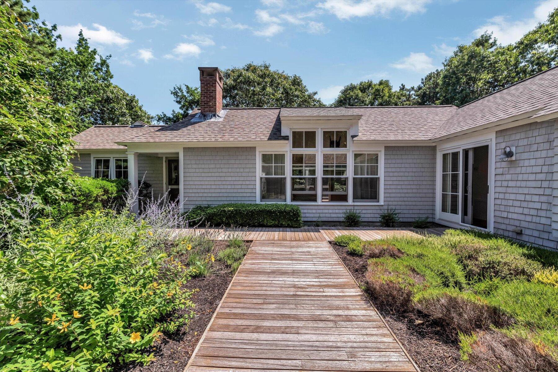 16 Tom's Hill Road Truro, MA 02666 - Photo 17 of 27 a front view of a house with a yard
