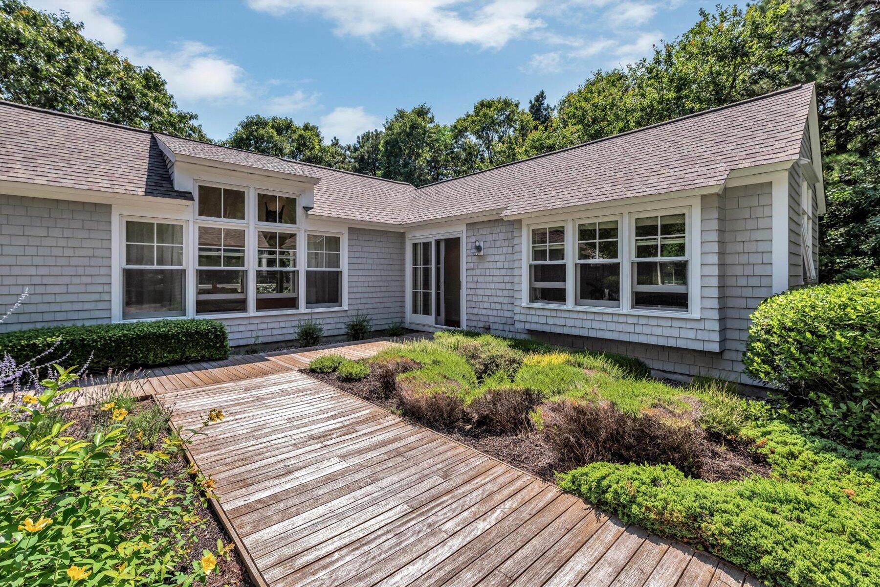 16 Tom's Hill Road Truro, MA 02666 - Photo 18 of 27 a house with a large window and garden space