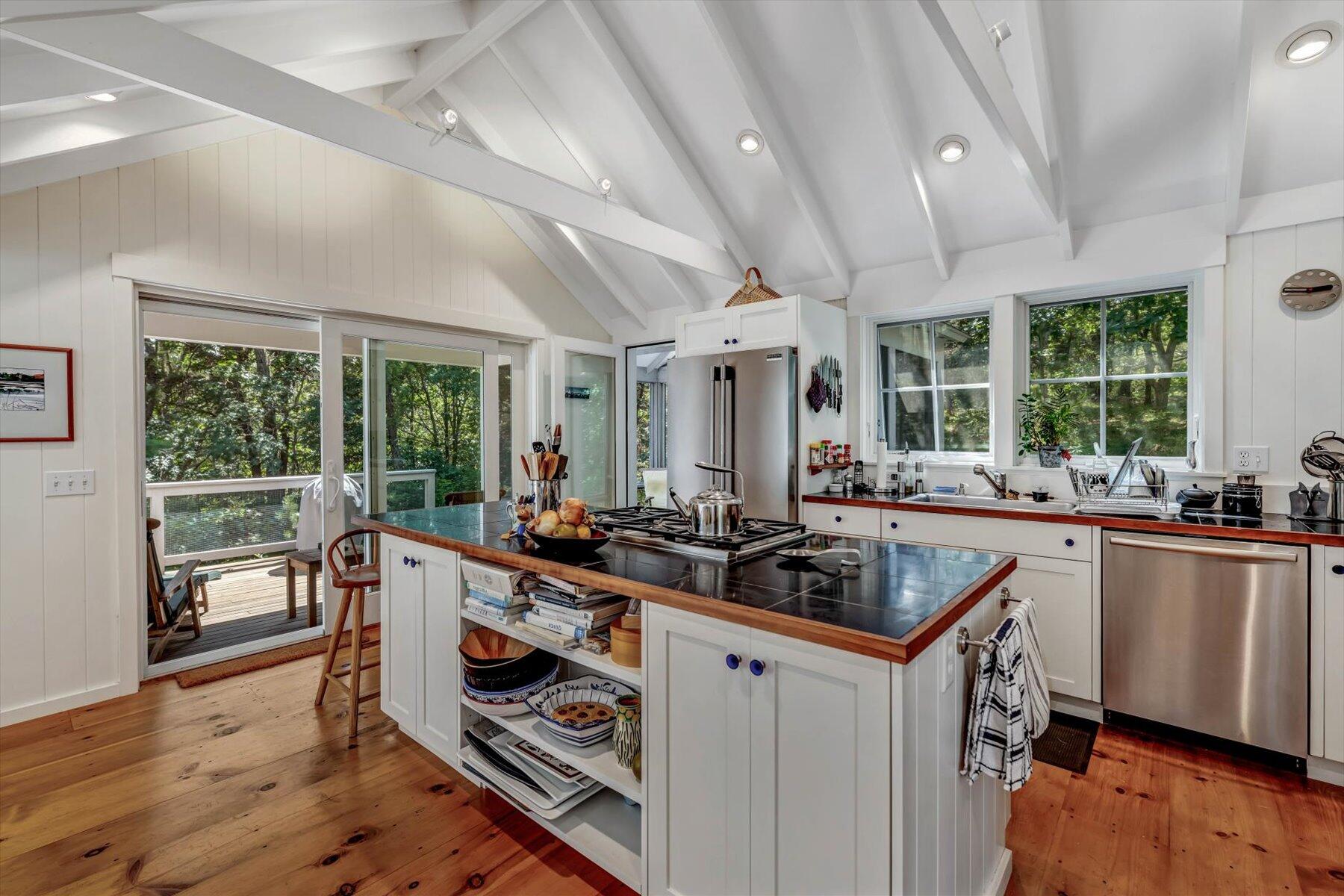 16 Tom's Hill Road Truro, MA 02666 - Photo 6 of 27 a kitchen with stainless steel appliances granite countertop a sink and a stove