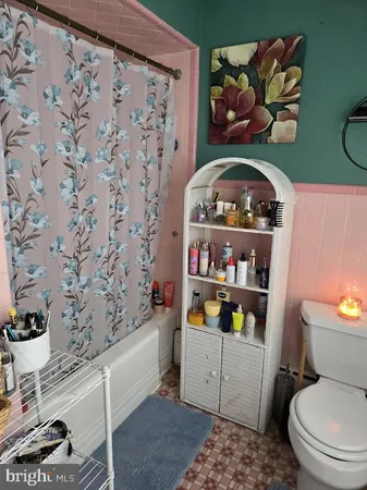 a bathroom with a toilet and a sink