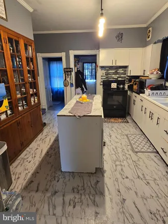 a large kitchen with stainless steel appliances granite countertop a stove and a refrigerator