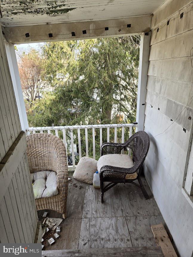 126 Maple Avenue Preston, MD 21655 - Photo 22 of 22 a balcony with a couch and a potted plant