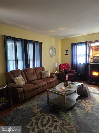 a living room with furniture couches and a window