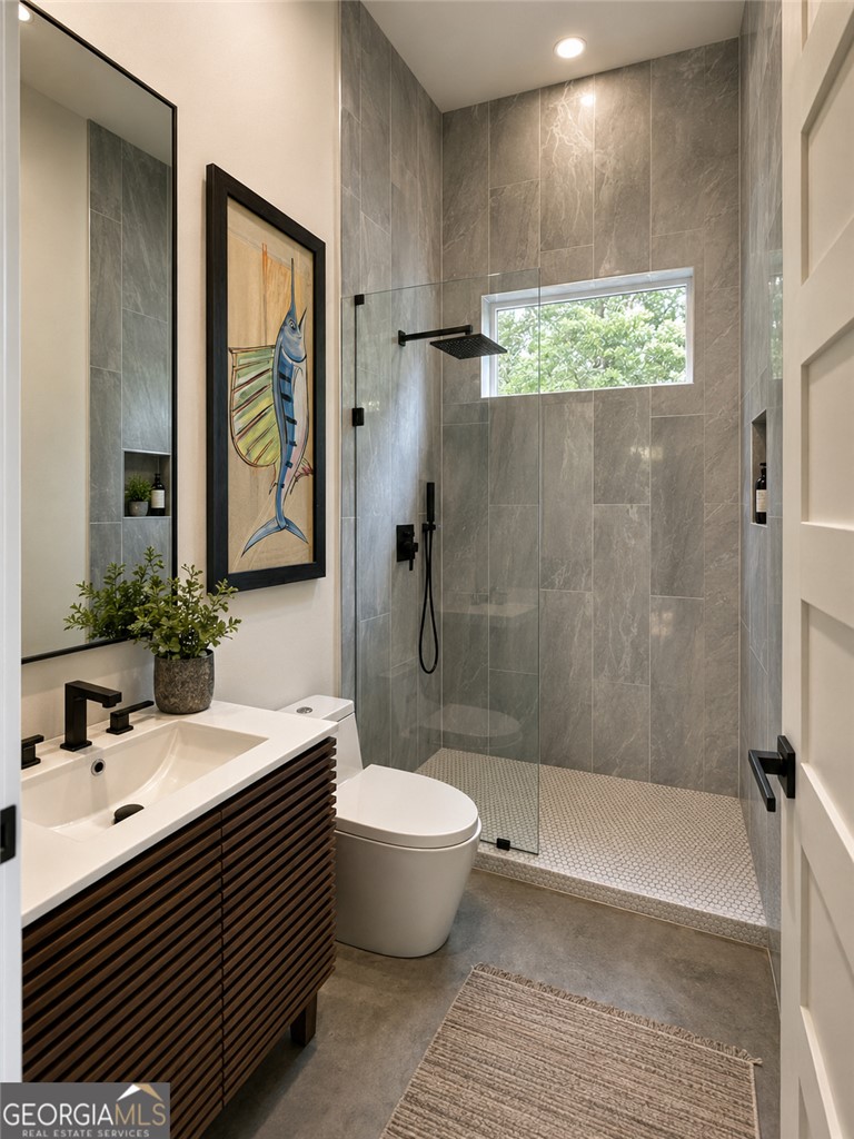 280 Hidden Point Road Hartwell, GA 30643 - Photo 21 of 46 A well-appointed bathroom with sleek gray tiling and a glass-enclosed shower.