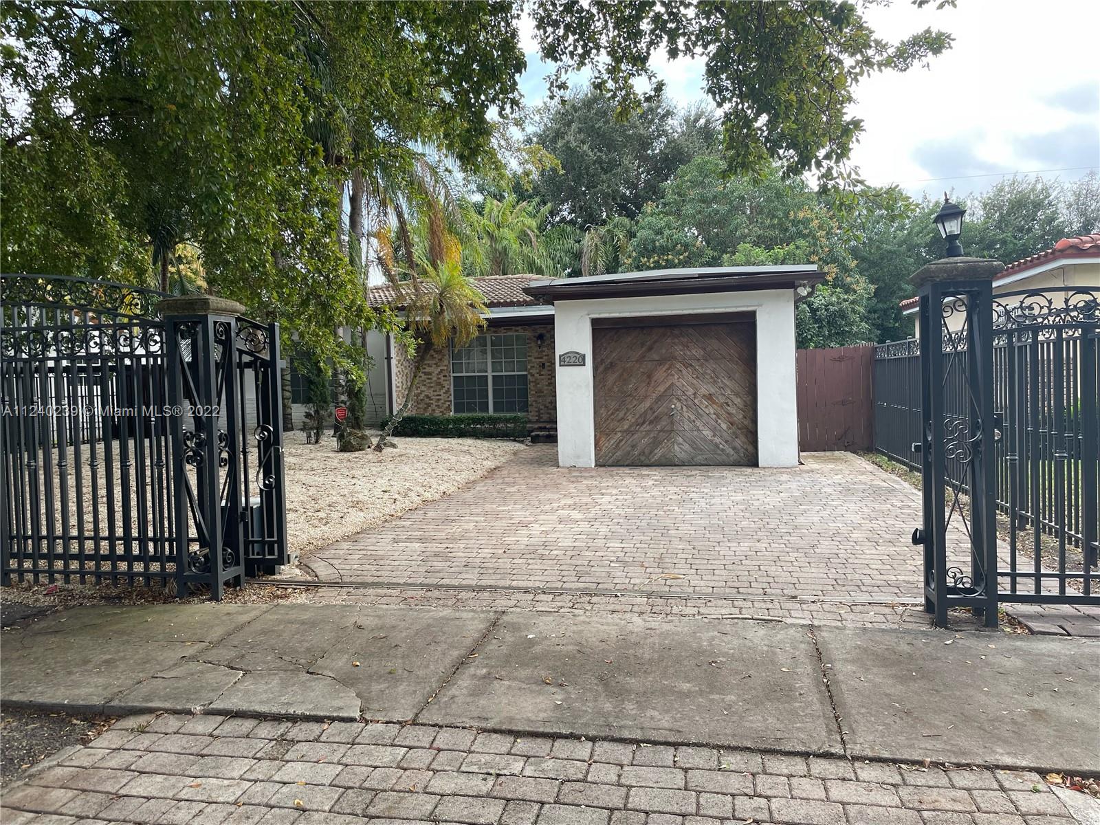 4220 Southwest 13th Street, Unit 4220 Miami, FL 33134 - Photo 1 of 14 a house with trees in front of it