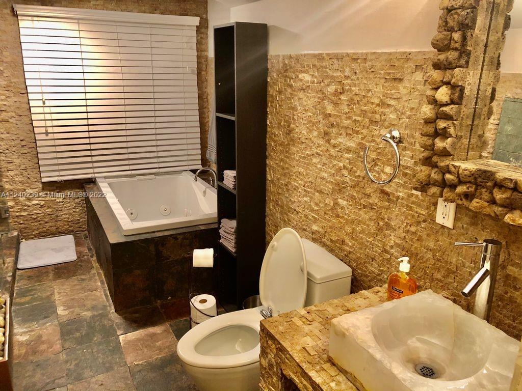 4220 Southwest 13th Street, Unit 4220 Miami, FL 33134 - Photo 11 of 14 a bathroom with a toilet and a sink