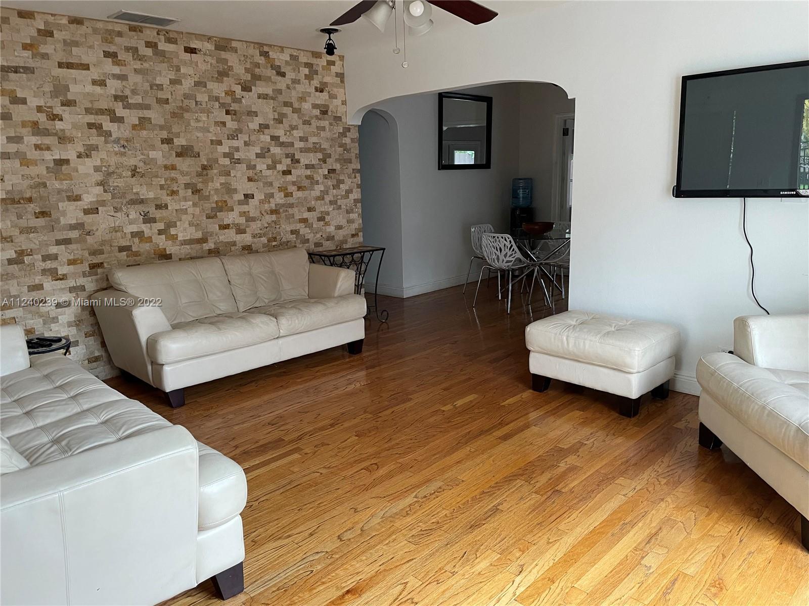 4220 Southwest 13th Street, Unit 4220 Miami, FL 33134 - Photo 12 of 14 a living room with couches and a flat screen tv