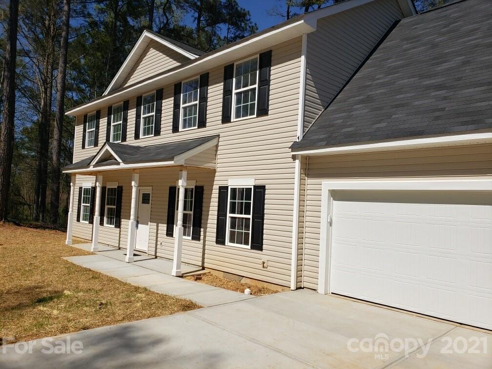 1810 Love Road Monroe, NC 28110 - Photo 4 of 13 a front view of a house with a garage
