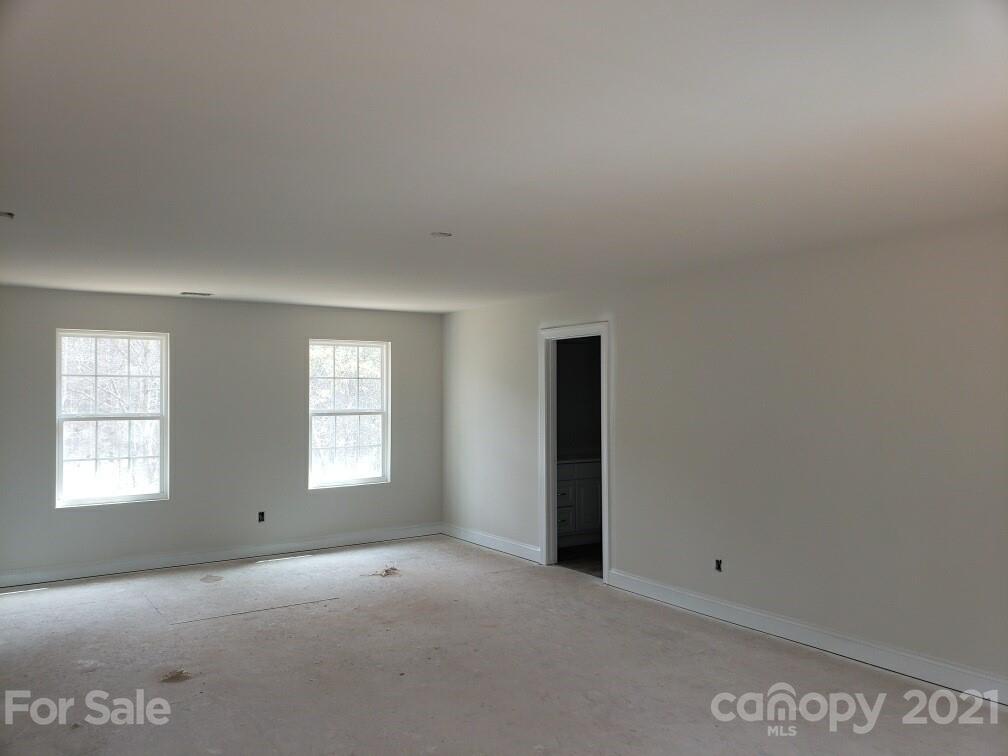 1810 Love Road Monroe, NC 28110 - Photo 8 of 13 an empty room with windows